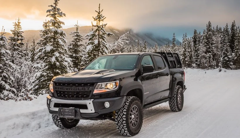 Chevrolet Colorado ZR2 with bed rack in snowy mountain forest